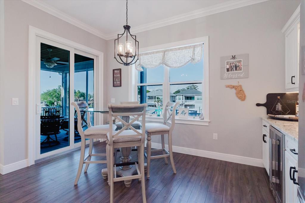216 High Street Tarpon Springs, FL 34689 - Photo 27 of 75 a view of a dining room with furniture wooden floor and chandelier