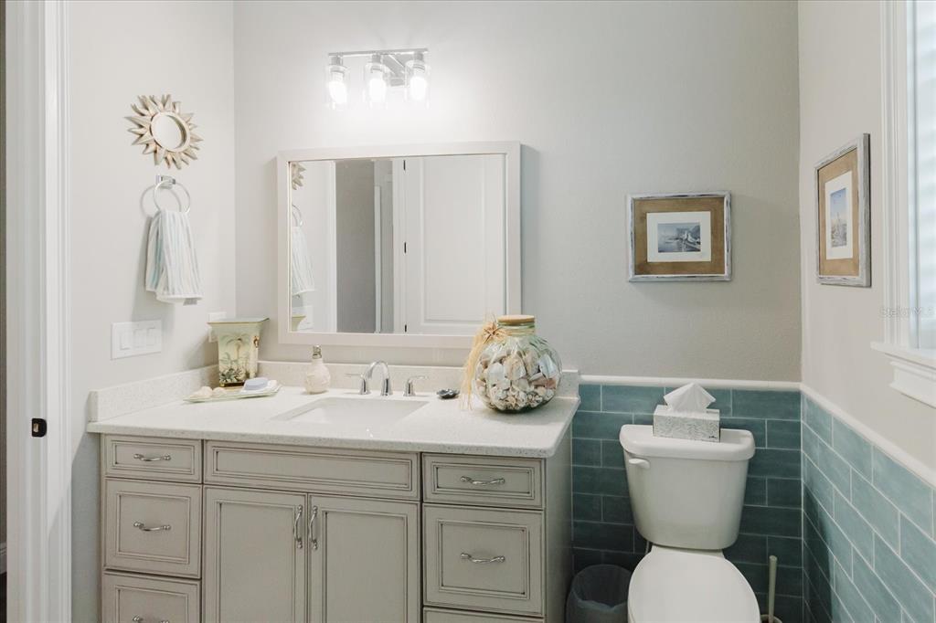 216 High Street Tarpon Springs, FL 34689 - Photo 41 of 75 a bathroom with a toilet a sink and a mirror