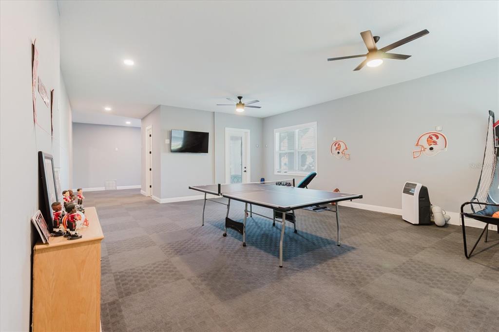 216 High Street Tarpon Springs, FL 34689 - Photo 48 of 75 a living room with furniture and a flat screen tv