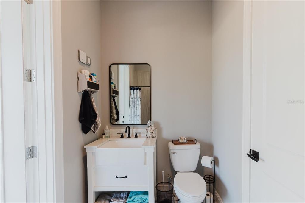 216 High Street Tarpon Springs, FL 34689 - Photo 51 of 75 a bathroom with a toilet sink and mirror