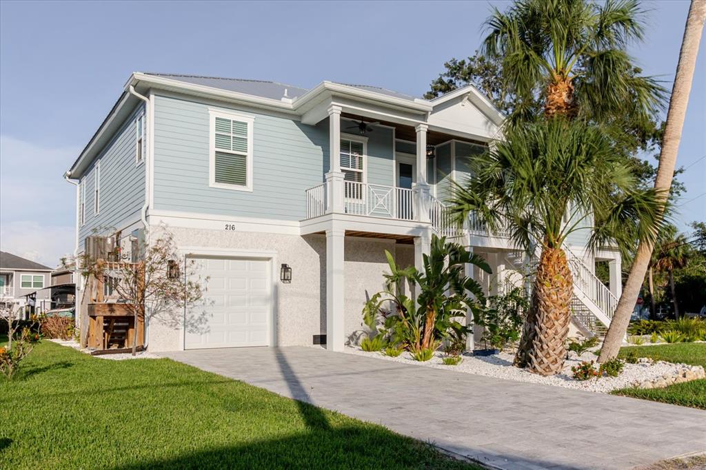216 High Street Tarpon Springs, FL 34689 - Photo 57 of 75 a front view of a house with a garden