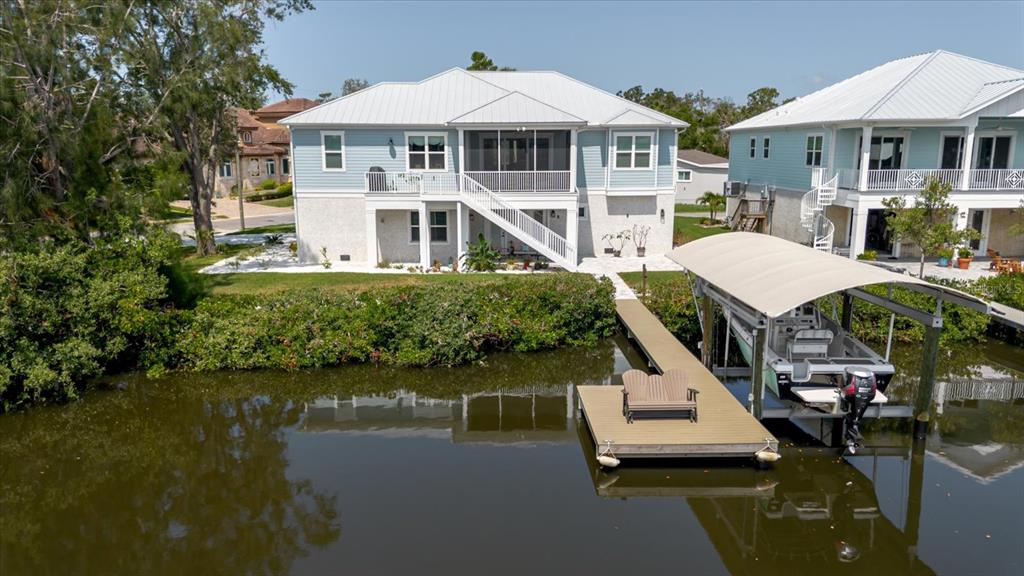 216 High Street Tarpon Springs, FL 34689 - Photo 60 of 75 a aerial view of a house with a yard table and chairs