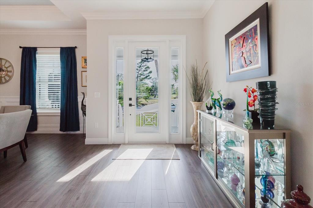 216 High Street Tarpon Springs, FL 34689 - Photo 10 of 75 a view of a hallway with wooden floor and a living room