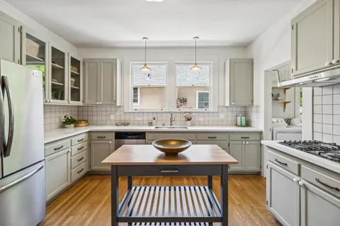 a kitchen with a stove a sink and a refrigerator