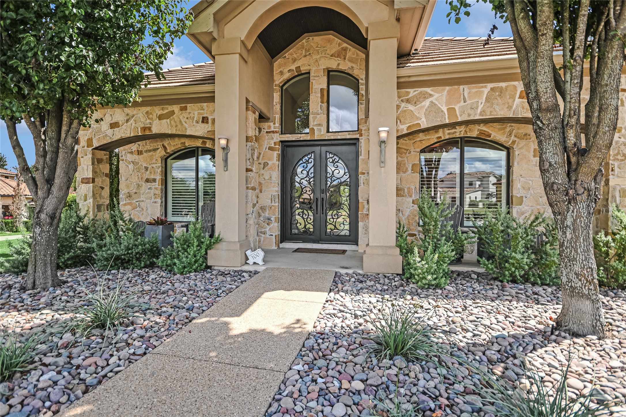 100 Dovetail Lane Georgetown, TX 78628 - Photo 4 of 34 Beautiful steel and glass double doors await your entrance through a covered front porch.