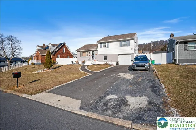 a view of a house with snow on the road