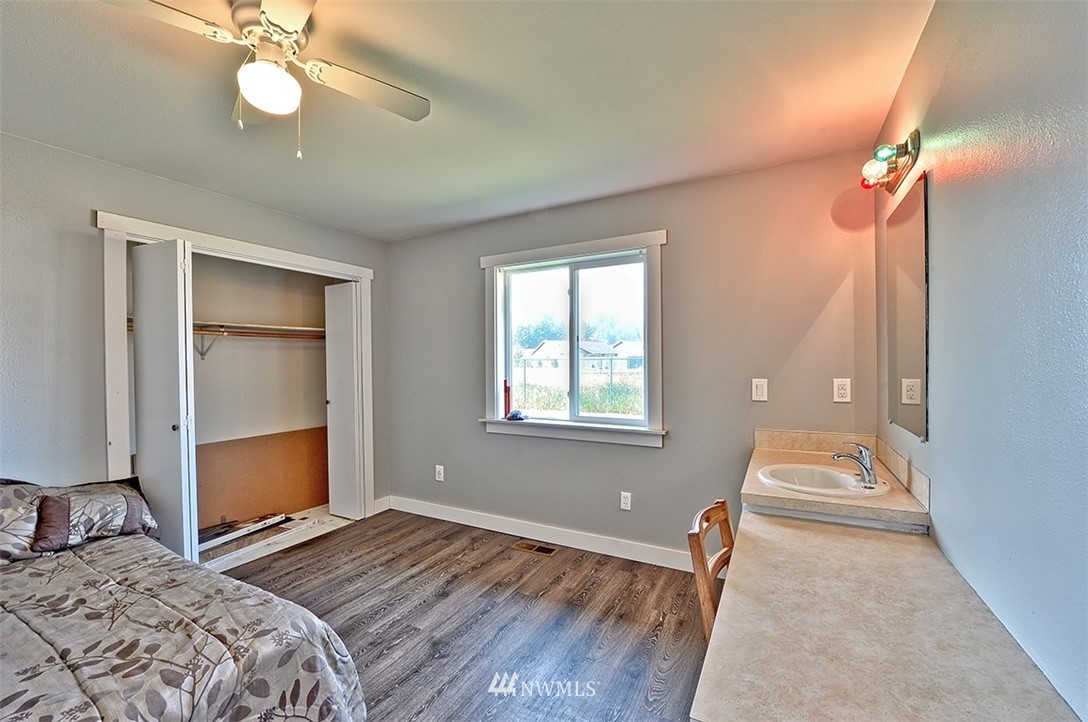 2452 Douglas Road Ferndale, WA 98248 - Photo 23 of 27 a bedroom with a bed and a chandelier