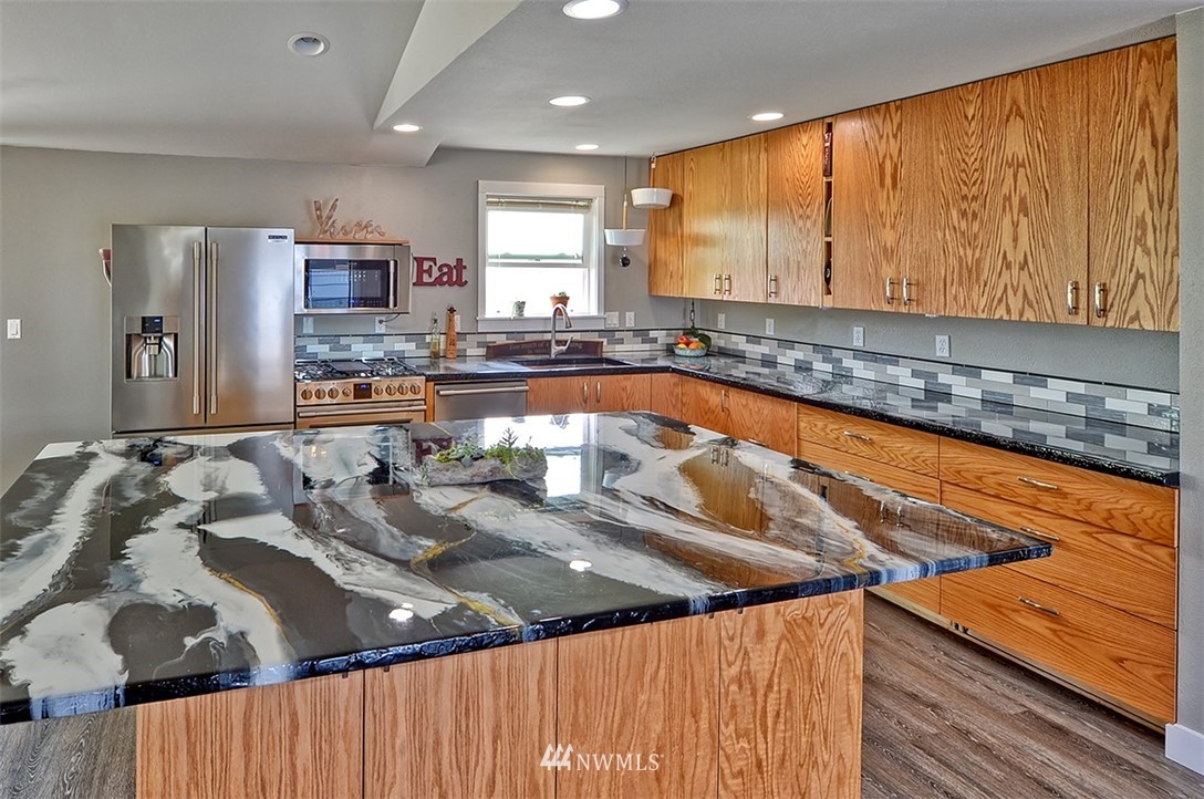 2452 Douglas Road Ferndale, WA 98248 - Photo 5 of 27 a kitchen with a sink and a refrigerator