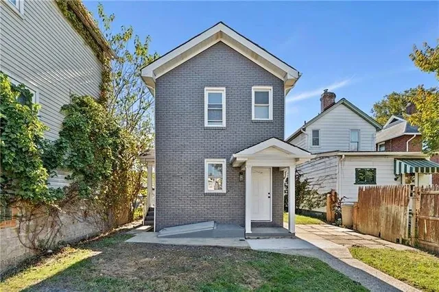front view of a house with a yard