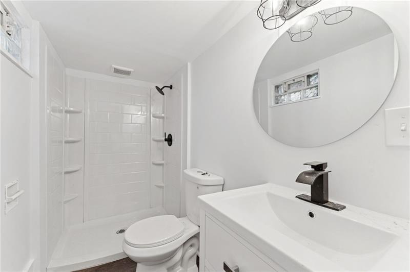 233 East 19th Avenue Homestead, PA 15120 - Photo 23 of 27 a bathroom with a toilet a sink and mirror