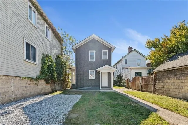 a front view of a house with a yard