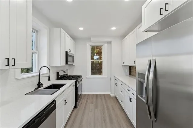 a kitchen with a sink stove and refrigerator