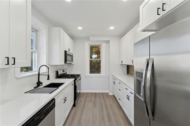 233 East 19th Avenue Homestead, PA 15120 - Photo 10 of 27 a kitchen with a sink stove and refrigerator