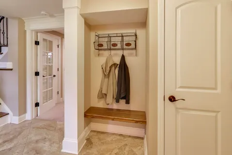 a view of a hallway with wooden floor and entryway