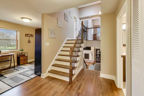 a view of entryway and hall with wooden floor