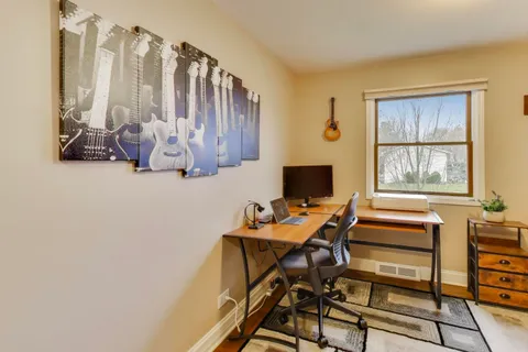 a bedroom with a bed dresser and a window