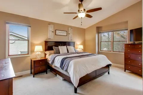 a spacious bedroom with a large bed and a window