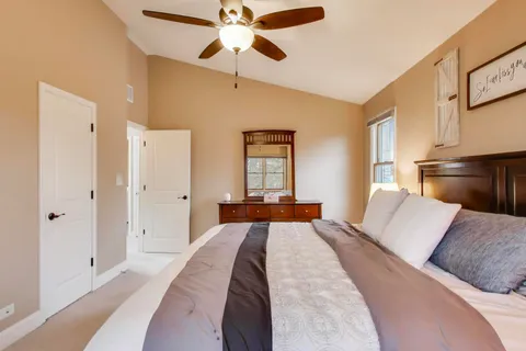 a bathroom with a granite countertop toilet a sink and a mirror