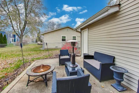 a view of a house and a back yard with a patio