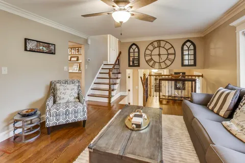 a living room with furniture and wooden floor