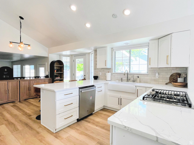 12169 Hidden Valley Road, Unit 44 Sandy, UT 84092 - Photo 11 of 49 Kitchen featuring white cabinetry, quartz countertops, a farmhouse sink, subway tile backsplash, and wood-finish flooring