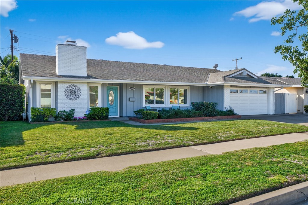 1610 East 20th Street Santa Ana, CA 92705 - Photo 1 of 43 a front view of a house with a garden