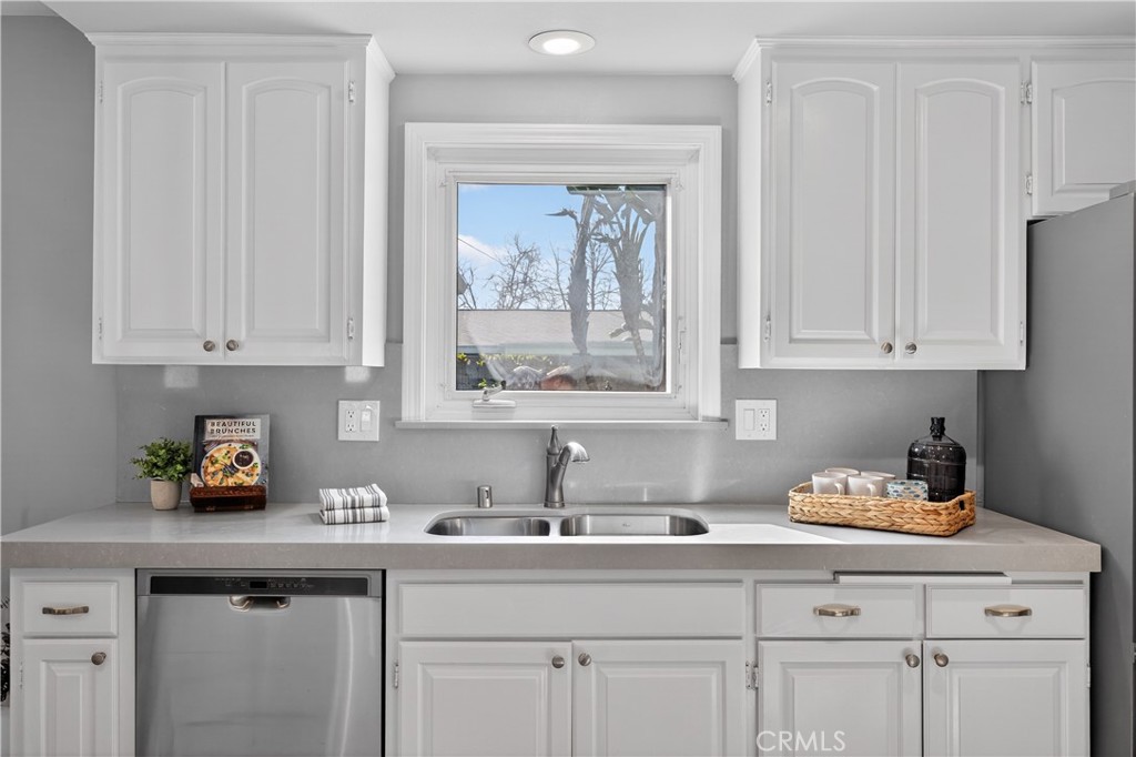 1610 East 20th Street Santa Ana, CA 92705 - Photo 14 of 43 a kitchen with white cabinets and a window