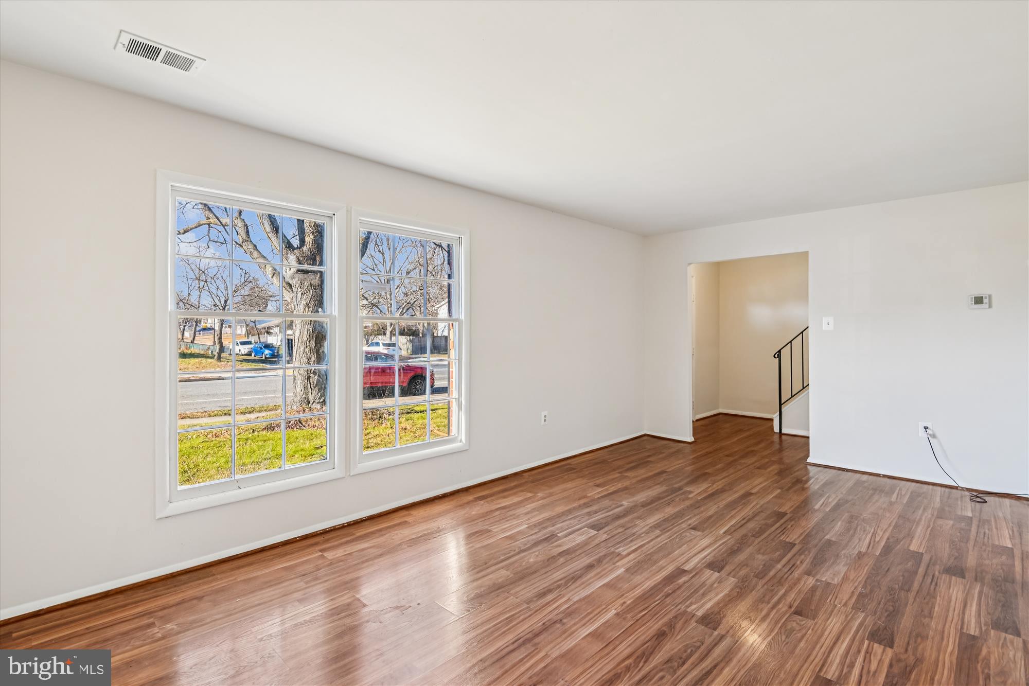 729 Chapelgate Drive Odenton, MD 21113 - Photo 22 of 64 a view of an empty room with window and wooden floor