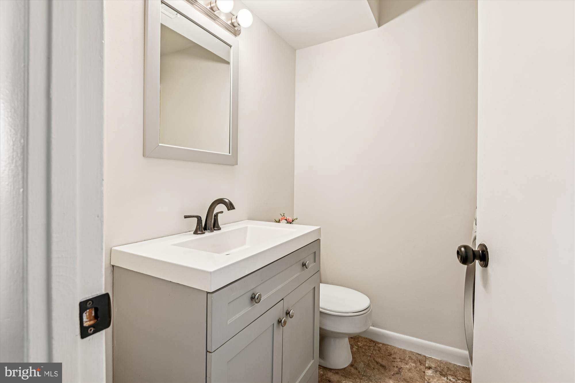 729 Chapelgate Drive Odenton, MD 21113 - Photo 36 of 64 a bathroom with a toilet sink and mirror