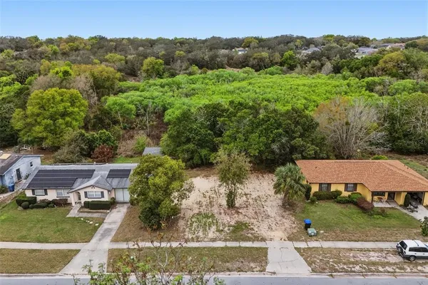 an aerial view of a house with yard