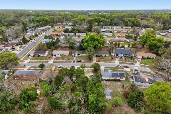 an aerial view of a house with a yard