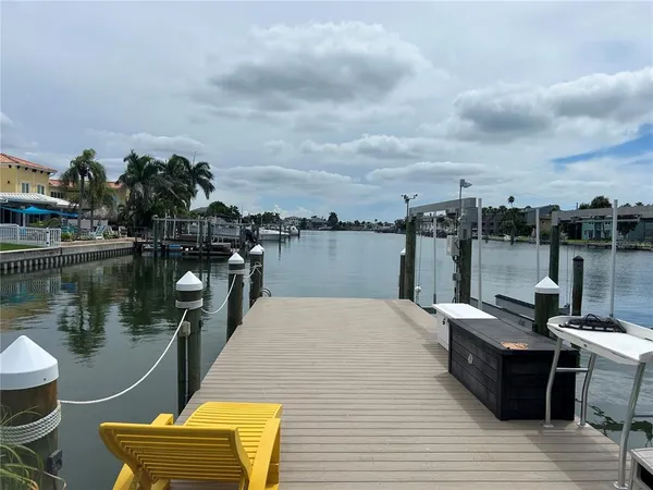 a view of a lake with chairs