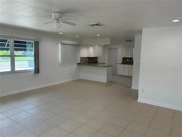 an empty room with windows and entrance