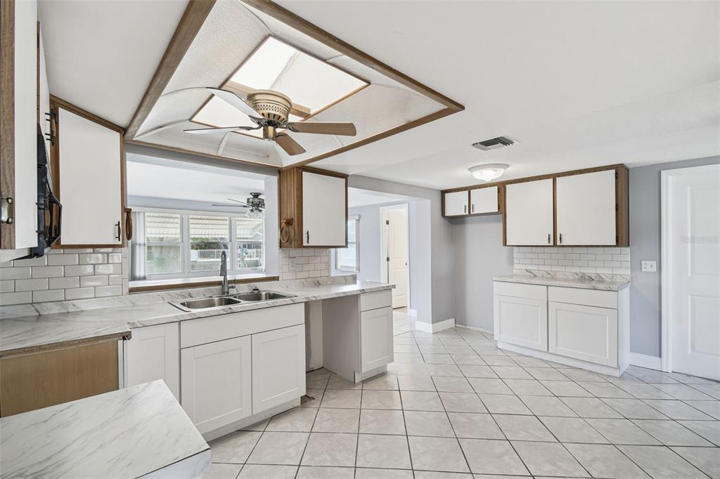 5410 Quist Drive Port Richey, FL 34668 - Photo 23 of 99 a kitchen with a stove a sink and a refrigerator