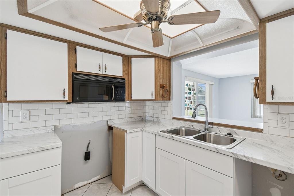5410 Quist Drive Port Richey, FL 34668 - Photo 28 of 99 a kitchen that has a sink and a stove with cabinets