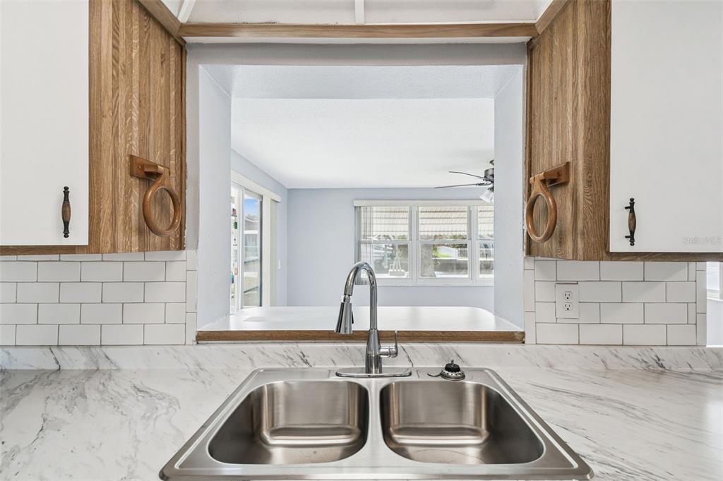 5410 Quist Drive Port Richey, FL 34668 - Photo 29 of 99 a kitchen with granite countertop a sink and a window
