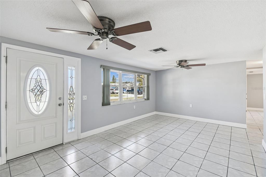 5410 Quist Drive Port Richey, FL 34668 - Photo 4 of 99 a view of an empty room with window and chandelier fan