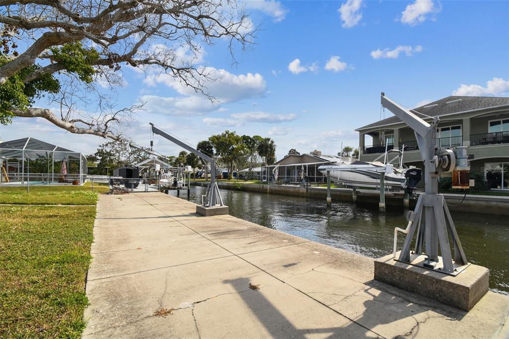 5410 Quist Drive Port Richey, FL 34668 - Photo 43 of 99 a view of a lake with a house in the background