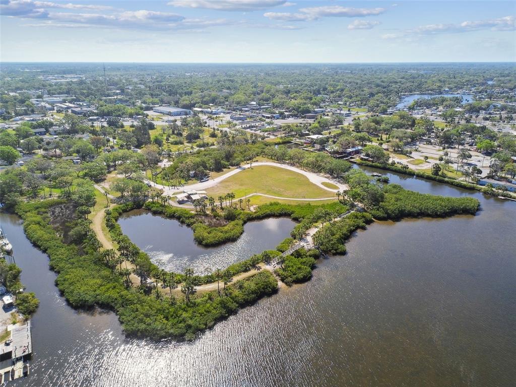 5410 Quist Drive Port Richey, FL 34668 - Photo 91 of 99 an aerial view of a house with a yard and lake
