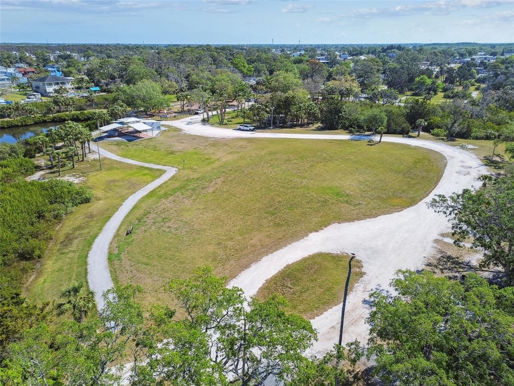 5410 Quist Drive Port Richey, FL 34668 - Photo 98 of 99 a view of a swimming pool and trees in the background