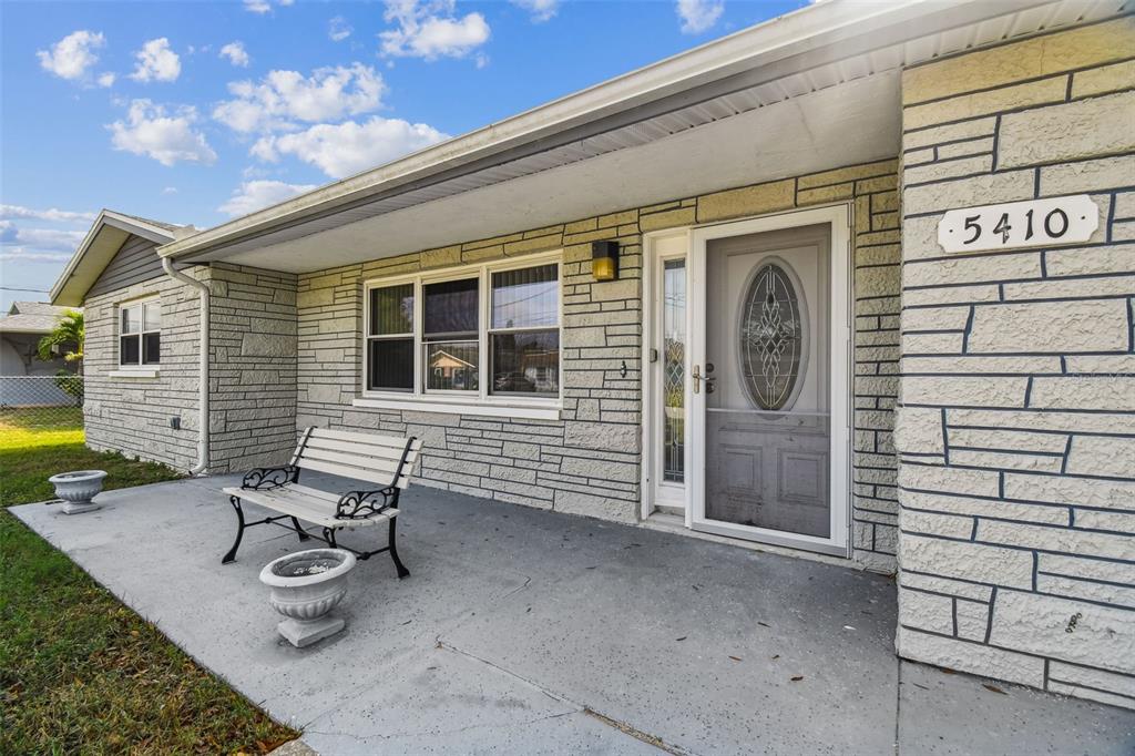 5410 Quist Drive Port Richey, FL 34668 - Photo 10 of 99 a view of a chair and table in back of the house