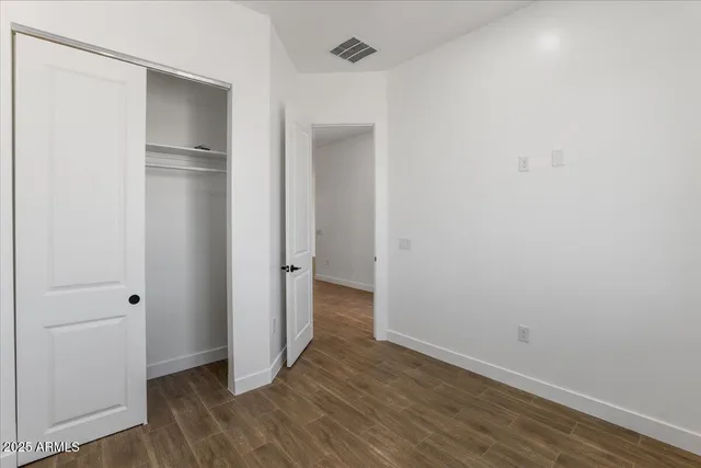 an empty room with a ceiling fan and window