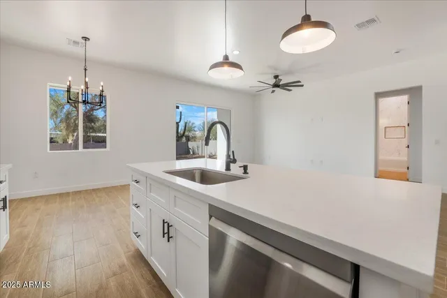 a kitchen with a sink cabinets and stainless steel appliances