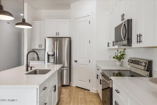 a view of a kitchen with furniture and a ceiling fan