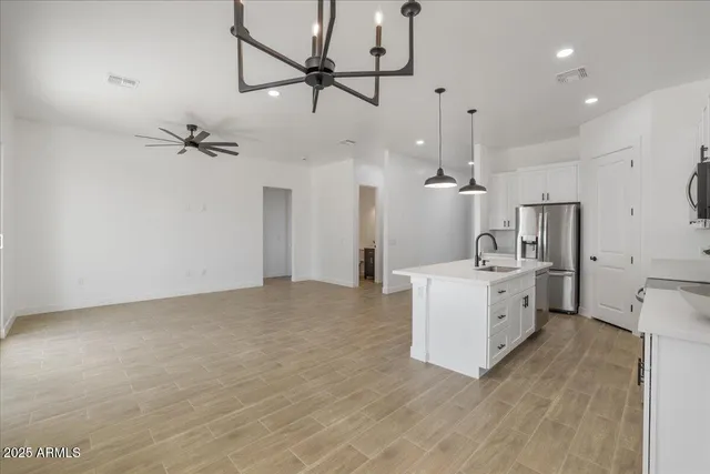 a kitchen with stainless steel appliances a stove refrigerator sink and microwave