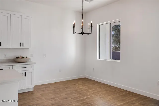 a view of kitchen with cabinets and wooden floor