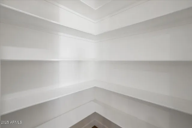 a view of a livingroom with a ceiling fan & entryway