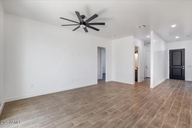 a view of a room with wooden floor