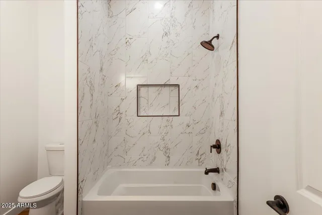 a bathroom with a bathtub and a toilet