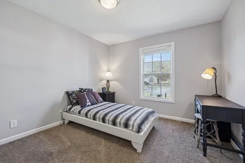 a bedroom with bed and a window